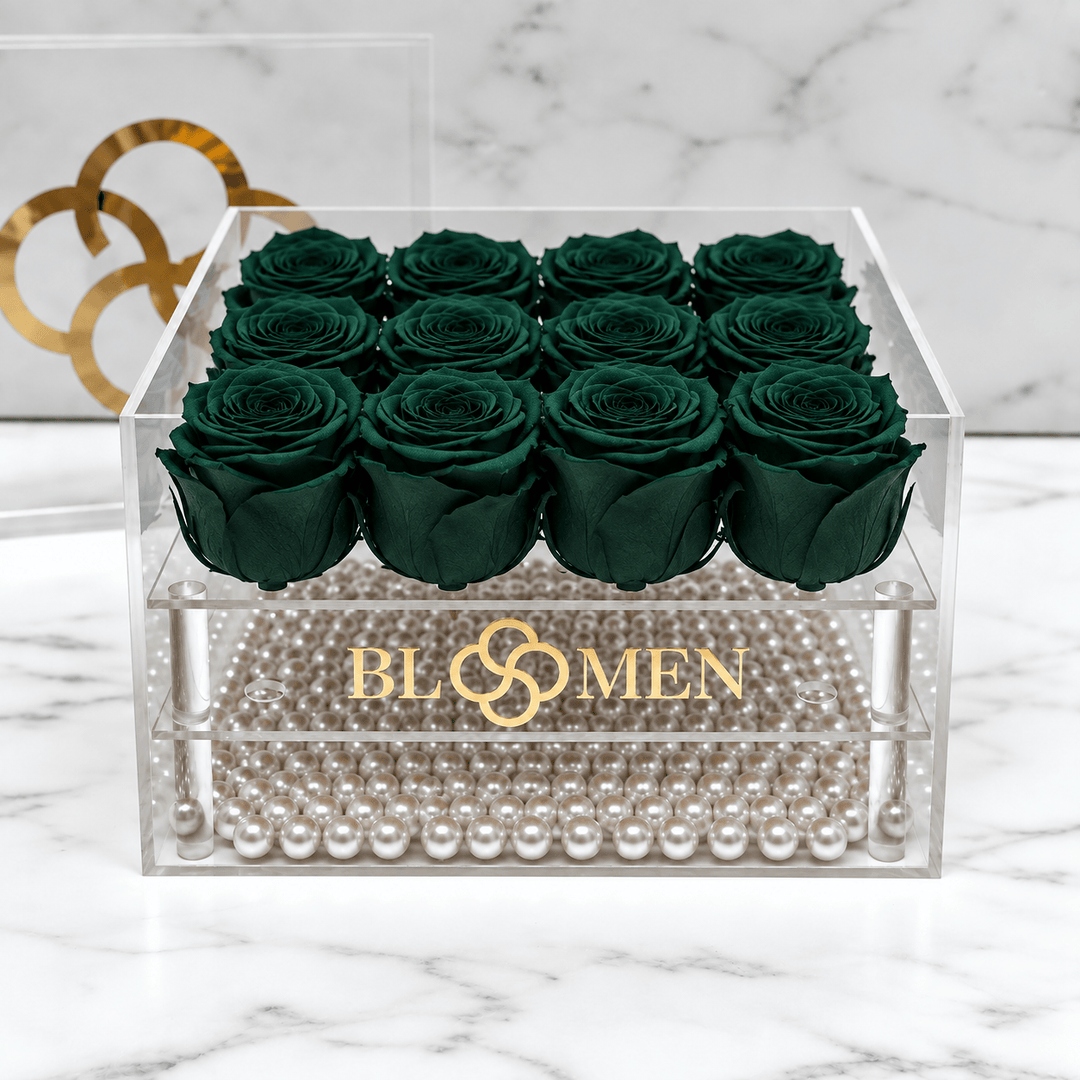 Top view of sixteen hunter green everlasting roses arranged in a four-by-four grid