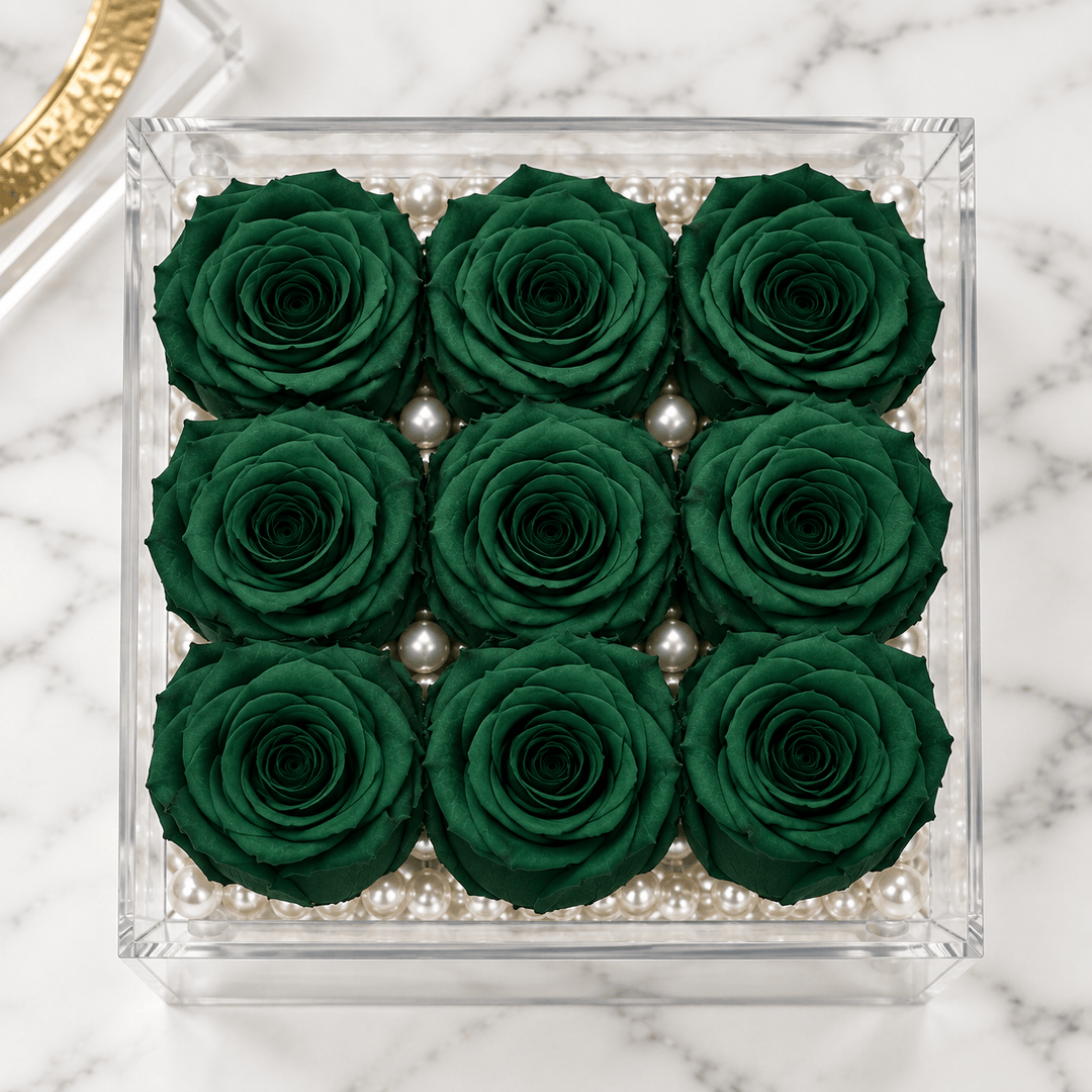 Top view of nine hunter green everlasting roses arranged in a three-by-three grid
