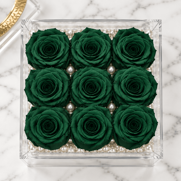 Top view of nine hunter green everlasting roses arranged in a three-by-three grid