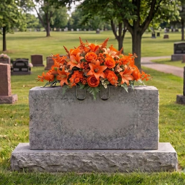 Tombstone Saddle: Lilies & Roses (Orange) - artificial memorial flowers on a headstone