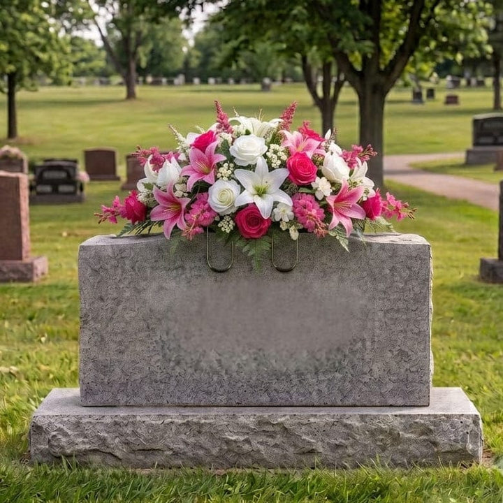 Tombstone Saddle: Lilies & Roses (Hot Pink & White) - artificial memorial flowers on a headstone