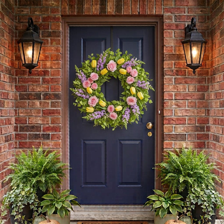 Spring door wreath with pink roses, yellow tulips and lavender snapdragons hanging on a front door