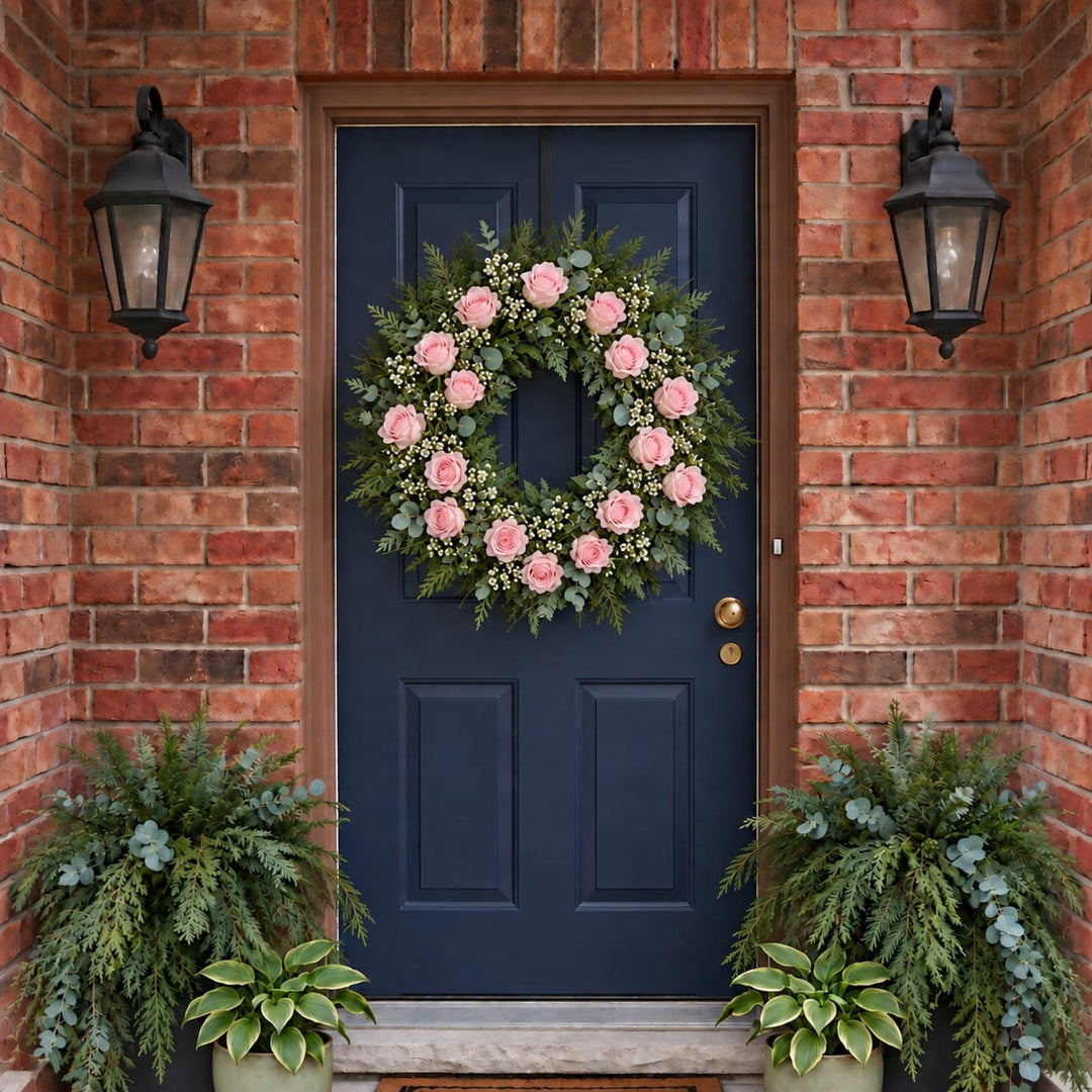 Winter door wreath with soft pink roses and baby's breath on a navy front door