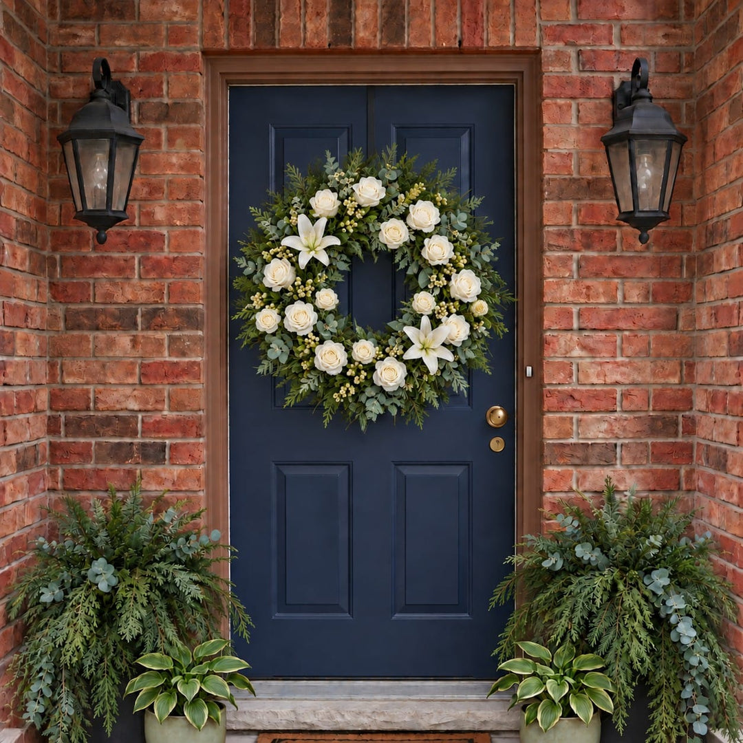 Winter door wreath with white roses, lilies and hypericum berries on a navy front door