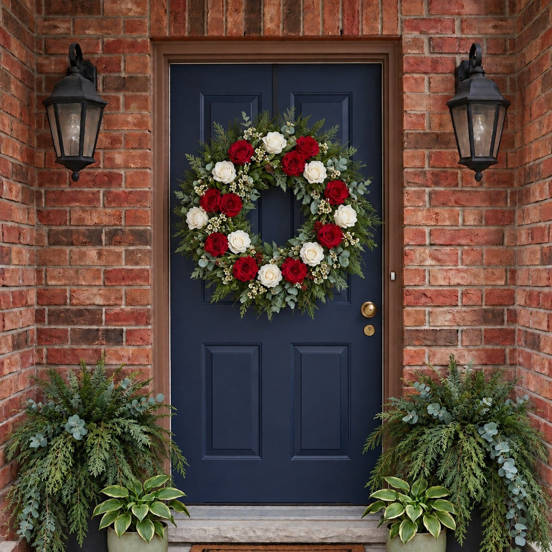 Winter door wreath with red and white roses and waxflower on a navy front door